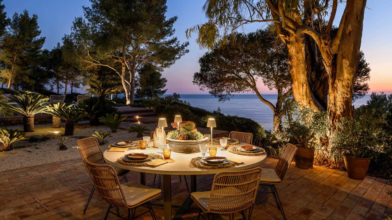 Romantic dinner on a private villa terrace overlooking a beautiful ocean view.