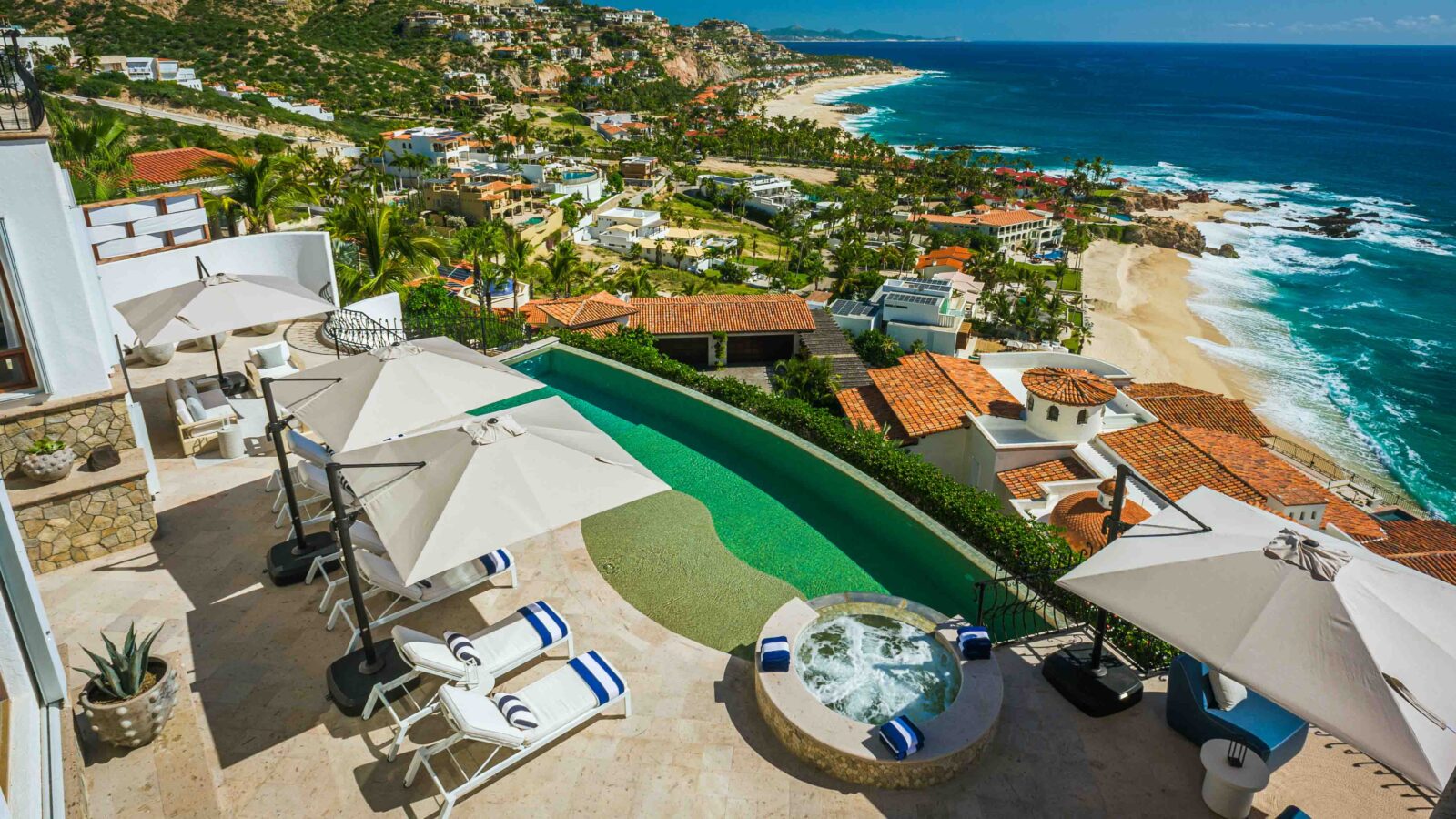 A modern villa in Los Cabos, Mexico, with a private hot tub and oceanfront view.