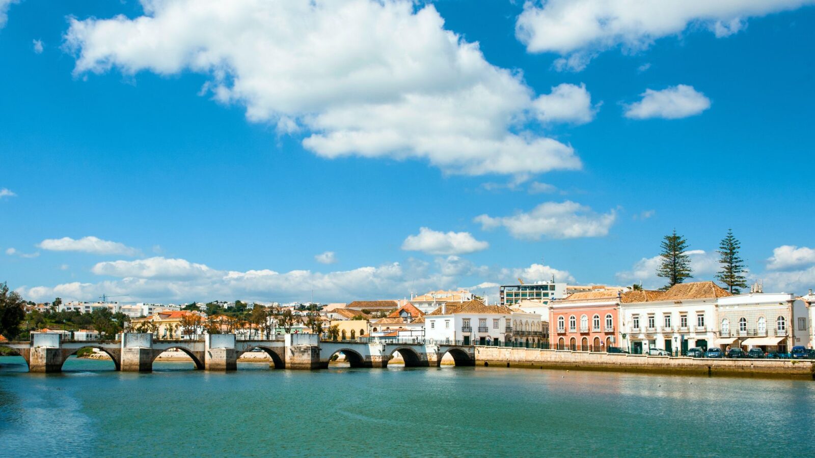 Roman bridge and pastel buildings in Tavira, Algarve.